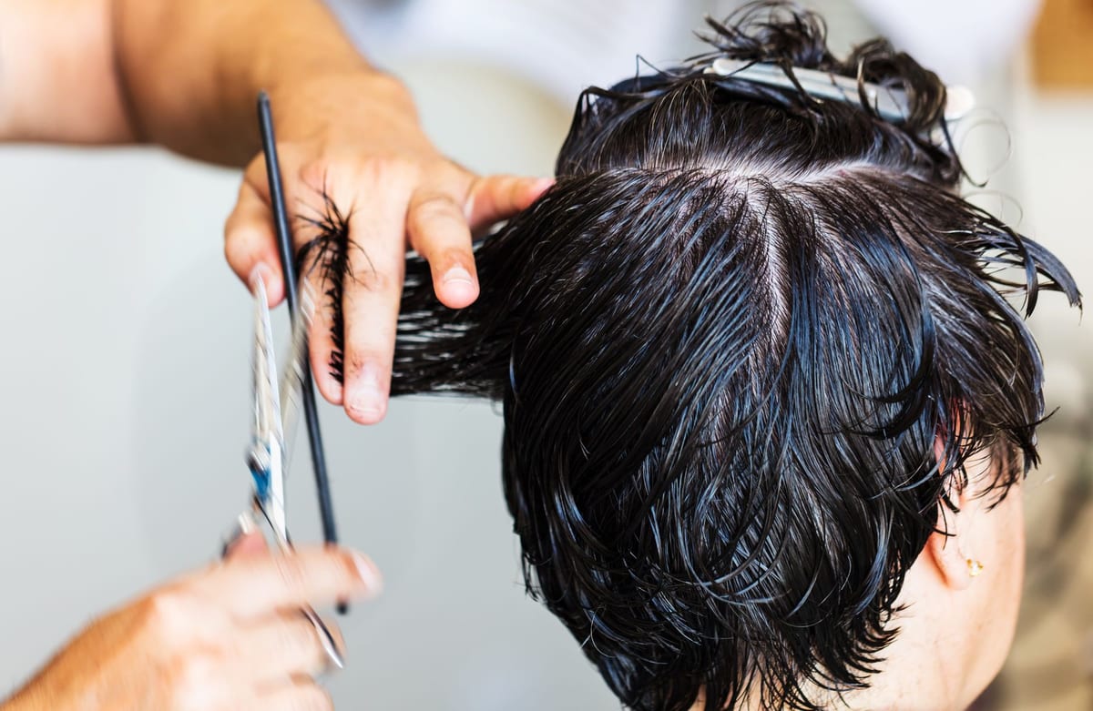 Close-up of a barber cutting a client's hair, similar to the work at Rio's Barber Shop